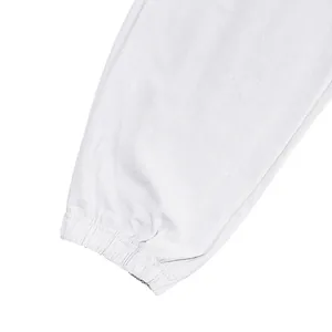 Detail view of the elasticated cuff on white linen men's jogger pants for summer.