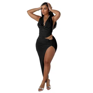 Detail shot of a sexy black two-piece set featuring a halter cowl neck top and high-slit maxi skirt