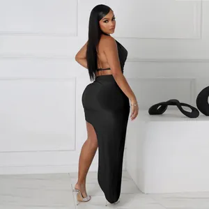 Side view showing details of sexy black halter neck high-slit maxi skirt set on model