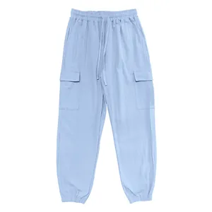 Detailed view of light blue linen-textured cargo pants with drawstring waist and pockets.