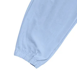 Detail shot showing the elasticated cuff of men's light blue linen casual jogger pants