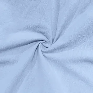 Detailed macro shot of light blue linen fabric texture for men's casual pants