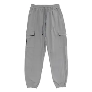 Macro view of men's linen cargo joggers focusing on elastic waist and pocket details.