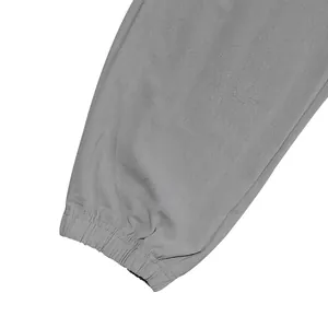 Detail view of gray linen pants showing the high-quality elasticated cuff design