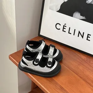 Close-up of silver quilted baby boy sandals with soft soles and velcro straps