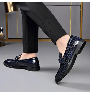 Detail view of navy blue crocodile pattern loafers for men in formal business style