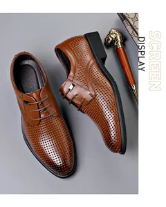 Close-up detail of stylish brown perforated leather business dress shoes for men