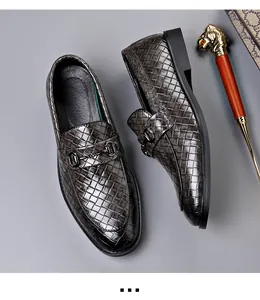 Detailed overhead view of men's woven leather loafers with classic metal horsebit buckle detail