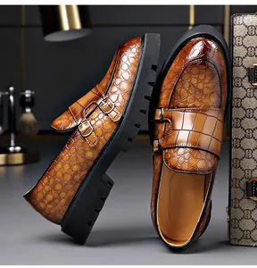 Detailweergave van bruine herenloafers met krokodillenstructuur, dubbele gesp en dikke zool
