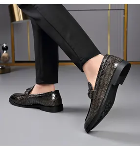 Macro view of stylish men's crocodile pattern loafers with a double buckle design