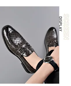 Macro view of men's formal woven leather loafers featuring a dark metal bit buckle