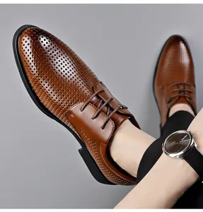 Detail of men's brown hollow-out leather dress shoes with breathable perforations.