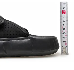 Detail view of black thick sole sandal being measured showing 4cm platform height