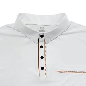 Detail shot of a white men's polo shirt with contrast stitching and chest pocket.