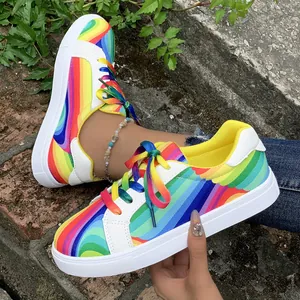 Detailed view of vibrant rainbow wave pattern and gradient laces on women's sneakers