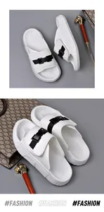 Close-up of stylish white men's sport slides with adjustable black buckle strap