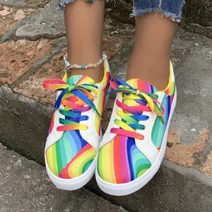 Outdoor street view of vibrant rainbow gradient women's casual sneakers with shell anklet