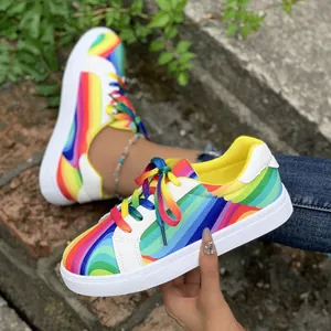 Detail shot of stylish women's rainbow gradient casual sneakers with thick white soles