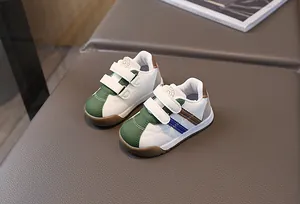 Detailed macro view of stylish white and green toddler PU leather walking sneakers