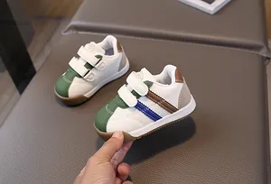 Detailed shot of white PU leather baby walking shoes with colorful accents and velcro straps