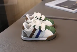 Detailed view of toddler walking shoes with green toe and hook-and-loop straps