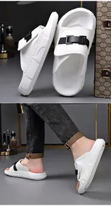 Detail of white men's slides with buckle strap and perforated upper on model.