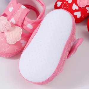 Detail shot showing the soft anti-slip dotted sole of pink heart patterned baby sandals