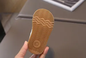 Detail view of non-slip rubber sole for toddler walking shoes featuring size 21 mark.