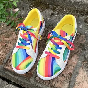 Top view of vibrant rainbow gradient women's canvas sneakers with matching laces