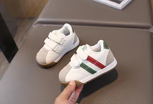 Detailed macro view of stylish white PU leather baby sneakers with red and green stripes