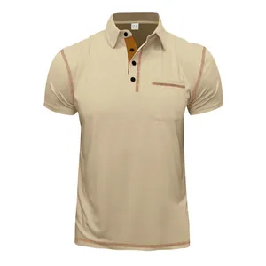 Front display of a beige polo shirt detailing chest pocket and contrast stitching.