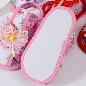 Detail shot of floral baby sandals showing the non-slip soft sole and decorative bow.