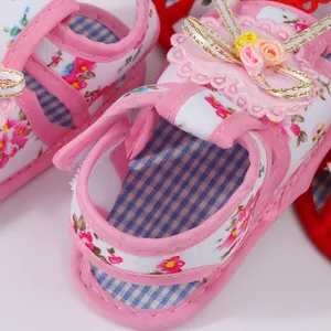Close-up of pink floral baby girl walking shoes with decorative 3D flowers
