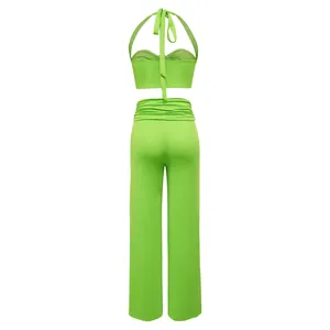 Back view of sexy lime green halter crop top and wide-leg trousers two-piece set outfit.