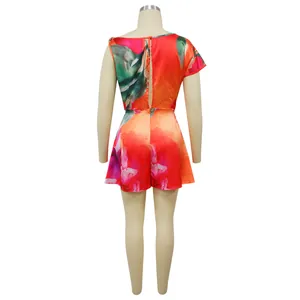 Back view of a vibrant floral print jumpsuit with a sexy backless design on a mannequin