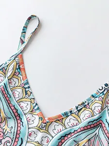 Detailed macro view of the V-neckline and colorful paisley print on a summer camisole dress