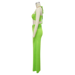 Side view detail of a vibrant lime green halter top and maxi skirt two-piece set