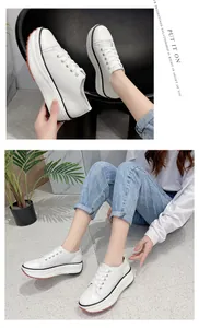 Detailed lifestyle view of women's white platform canvas sneakers with lace-up design