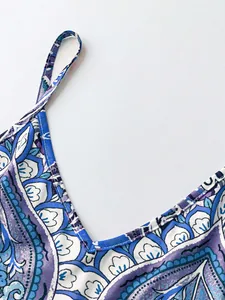 Close-up detail of V-neckline and strap on retro blue paisley print summer dress