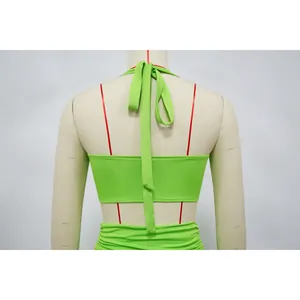 Back view detail of lime green halter neck two-piece summer set on a mannequin.