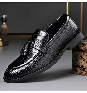 Close-up of black men's loafers featuring crocodile embossed leather and tassels