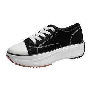 Women's stylish black and white low-top platform canvas shoes with lace-up design