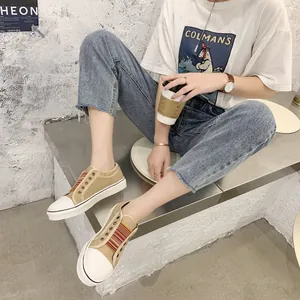 Women's vintage khaki canvas sneakers with striped elastic bands and thick white soles