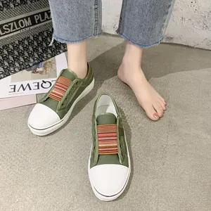 Detail view of olive green women's canvas shoes with vibrant striped elastic bands