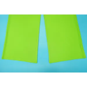 Detailed view showing the stitching on the hem of lime green women's trousers.