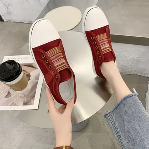 Detailed view of women's red canvas platform sneakers with colorful elastic band