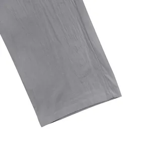 Macro view of breathable linen fabric and hem detail on gray men's loose pants