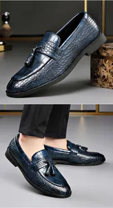 Close-up detail of navy blue crocodile embossed leather loafers with elegant tassels