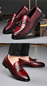 Close-up of elegant burgundy crocodile pattern leather loafers with stylish tassel for men