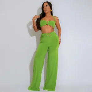 Lime green two-piece set featuring a halter crop top and wide-leg pants with gold buckles